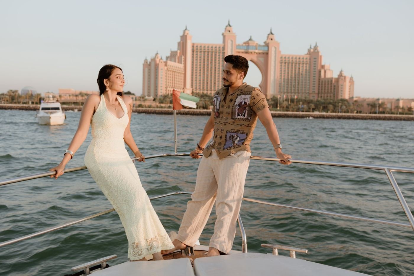 Couple on the bow of a yacht with Atlantis The Palm behind